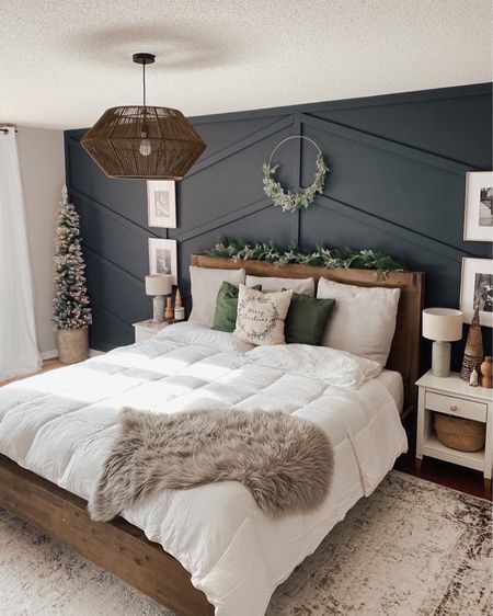 Christmas bedroom Decor-white bedding with a Merry Christmas pillow. Faux fur blanket and green cushions. Christmas tree in the corner with garland on the bed and a wreath above. #christmasdecor #christmastree #christmasbedroom #bedroomdesign #arearug

#LTKHoliday #LTKSeasonal #LTKhome