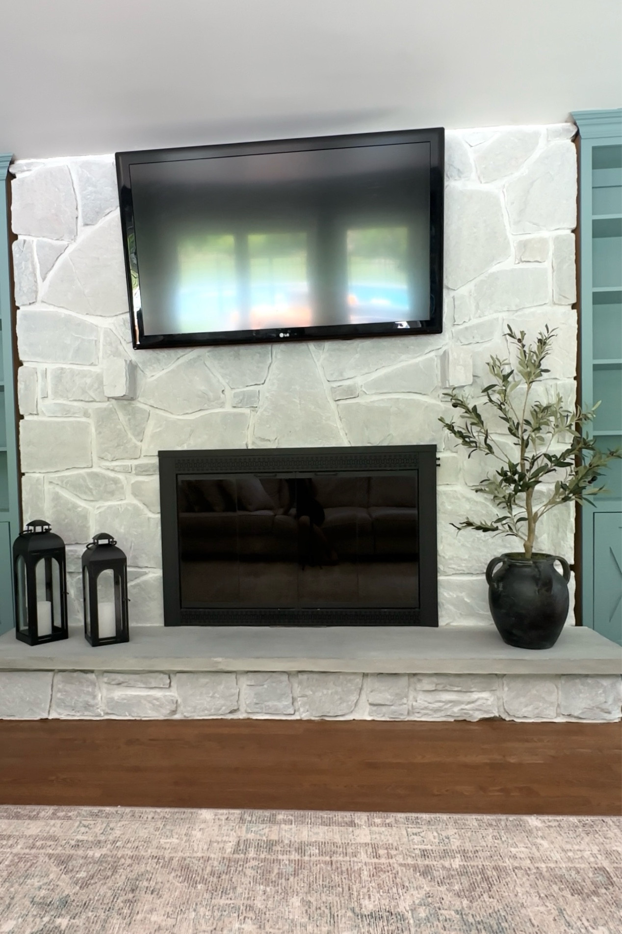 Fireplace decor. Living room decor. Lanterns. Indoor lanterns. Black lanterns. Decorative pot. Indoor pot. Decorative vase. Pottery vase. Pottery barn vase. Black vase. Walmart lantern. Afloral olive tree. Olive tree. Faux olive tree. Decorative accents.

#LTKHome #LTKStyleTip