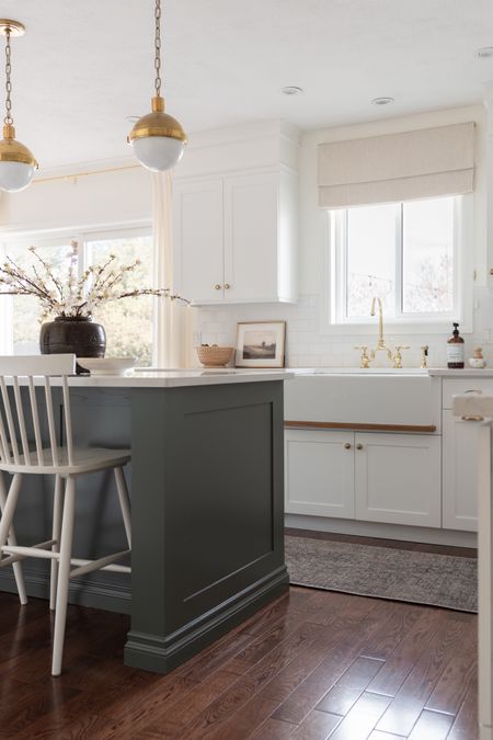 I painted our kitchen island a beautiful shade of green, Rainy Afternoon from Benjamin Moore, to add warmth and character to our white kitchen. 

Brass globe pendants, Roman shade, Windsor counter stools, vintage vase, blossom stems, vintage landscape art,brass bridge faucet



#LTKhome