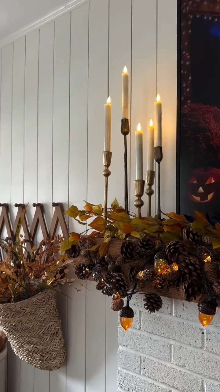 (8/27/25) 🍂✨ Fall mantel styling is officially underway over here and it might be my favorite one yet! I layered two pinecone garlands (this gives the garland a fuller look) with the sweetest little acorn string lights, added a mix of candlesticks for a cozy glow. Lastly, I tucked in a few fall stems (from Hobby Lobby) for some softness.

Mantels can be tricky to decorate, but keeping a balance of texture (garland), height (candlesticks), and softness (stems + lights) makes everything feel pulled together. 🍁

If you’re looking for simple fall mantel decor ideas to bring a little autumn magic into your home, this setup is easy to recreate and gives allll the cozy vibes!! 🕯️ 

 #LTKSeasonal #LTKHome #LTKFindsUnder50