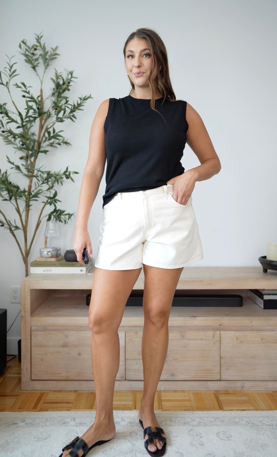 Classic black and white for an effortless summer look. A sleeveless black top, white denim shorts, and black slide sandals make this an easy outfit for everyday plans, vacation, or lunch out.

black and white outfit, white denim shorts, black tank, summer outfit, casual chic, black sandals, elevated basics, everyday summer style

#LTKTravel #LTKSeasonal #LTKootd