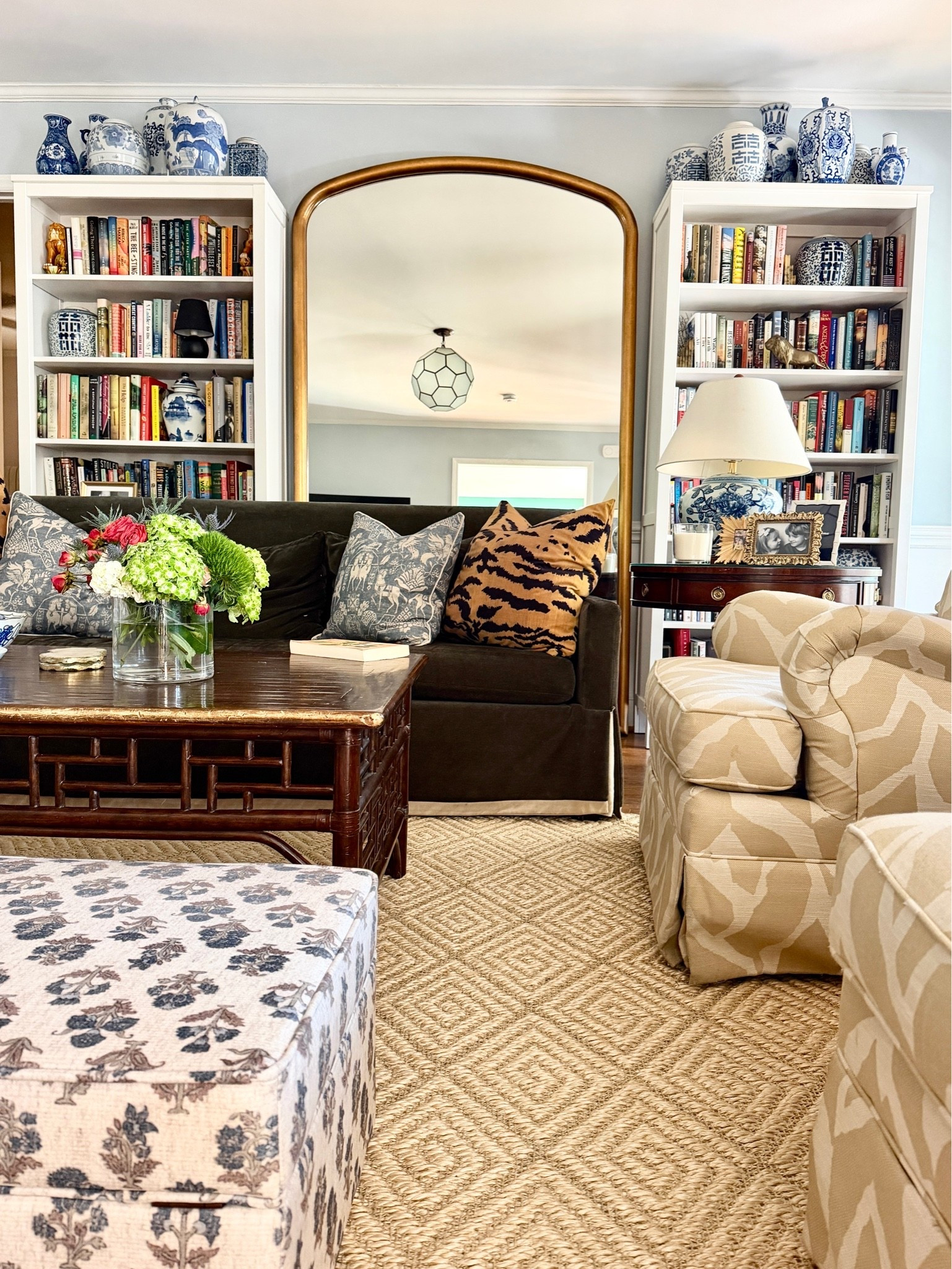 Traditional living room styling. Floor mirror, sisal rug, block print ottoman, tiger pillows

#LTKHome
