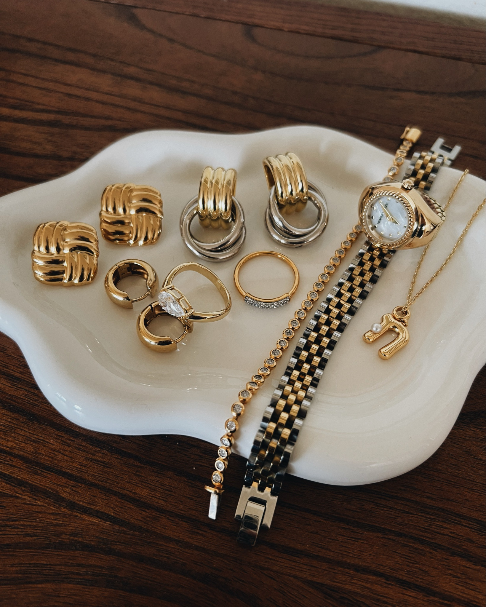 (Mostly) affordable everyday gold jewelry! These are what I rotate daily. My watch ring is from Hearts Valley- I’ve linked a similar one. ALSO The Fiji Bar ring is so sparkly irl but didn’t photograph well at all. 
-
Amazon gold jewelry- affordable gold jewelry- 14k gold jewelry- lab diamond tennis bracelet- 14k gold watch strap bracelet- initial necklace - Pavoi - chunky earrings - Mejuri - Monica Vinader - pave diamond ring - Pavoi pear solitaire diamond ring - everyday gold jewelry - heaven mayhem dupe earrings - gold and silver earrings - square gold earrings - chunky huggie hoops 14k gold- round diamond bezel tennis bracelet 

#LTKFindsUnder100 #LTKOver40 #LTKStyleTip