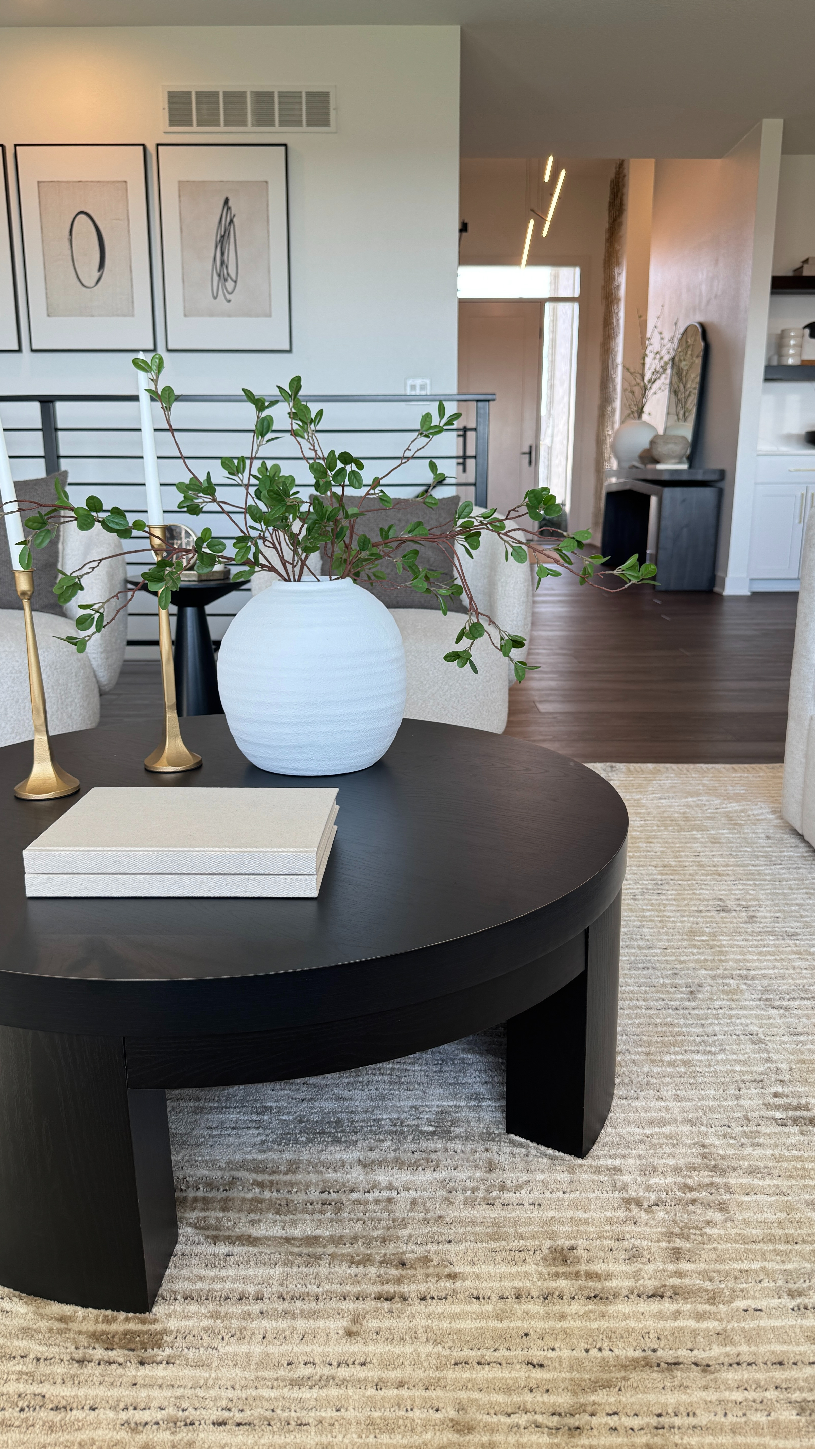 If you need a rug that can actually handle real life… this is it ✨ Neutral, pretty, and so easy to clean. On sale now! Love how it ties together my coffee table, swivel chairs, art, and table decor. 

 #LTKHome #LTKSaleAlert