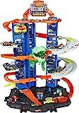 Hot Wheels Track Set and 2 1:64 Scale Toy Cars, City Garage with Moving T-Rex Dino, Storage for 1... | Amazon (US)