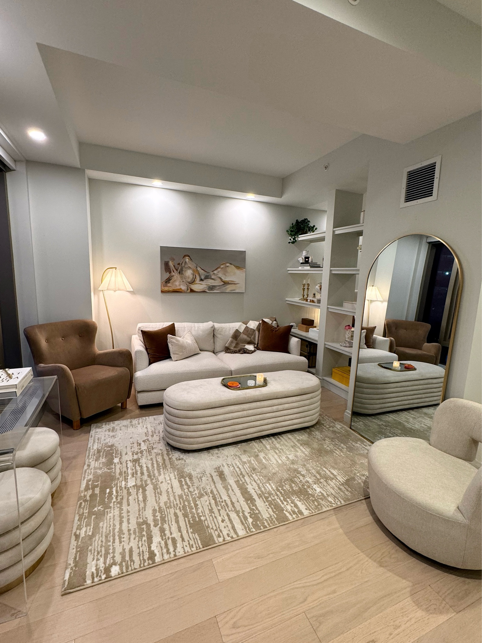 Living room decor. LOVING this brown wingback accent chair from target, it’s so cozy and brings some warmth to the space! 
-
Home decor, apartment decor, boucle couch, ottoman with storage, home, swivel accent chair, arched mirror, acrylic table, west elm, Anthropologie mirror vanity tray, coffee table decor, arched floor lamp, pleated shade, gold floor lamp

#LTKhome