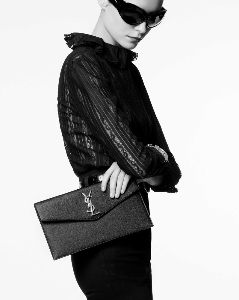 Small envelope clutch with a flap featuring metal YSL initials. | Saint Laurent Inc. (Global)