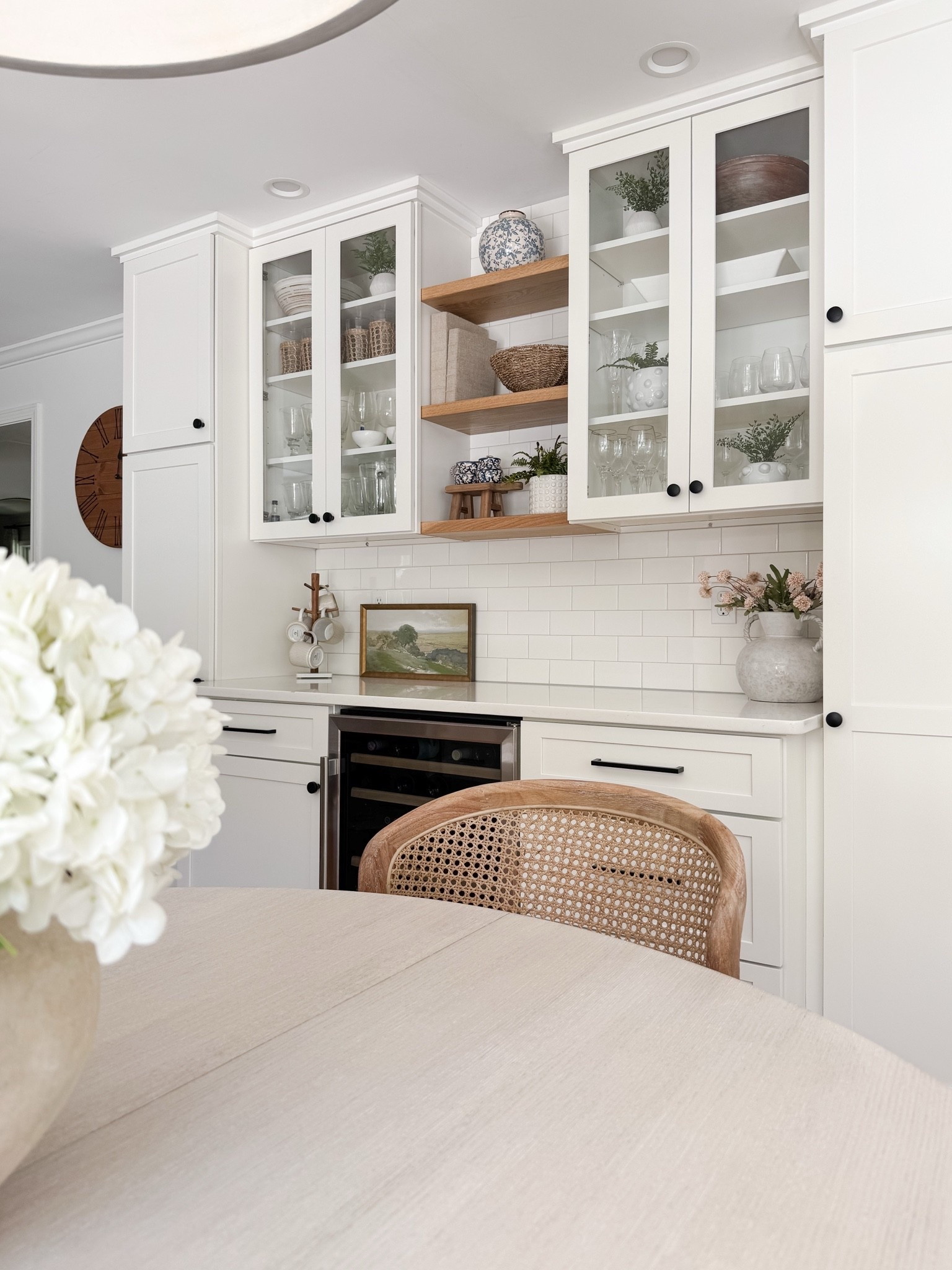 Coastal dining room styled with round wood table, woven dining chairs, faux hydrangeas, and soft natural light for relaxed coastal dining.

coastal dining room decor, round wood dining table, woven dining chairs, faux hydrangea centerpiece, neutral dining room styling, coastal interior decor, light coastal home, neutral dining room inspiration, sherricalnanhome

#LTKHome