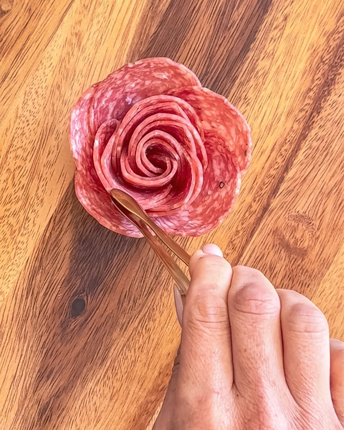 HOW TO SERVE A SALAMI ROSE ⬇️

I get asked all the time: “How do you eat a salami rose? Do you just shove the whole thing in your mouth?!” 😂 Don’t worry, I’ve got you covered!

Nobody wants to be the first to break apart the rose (it’s almost too pretty to touch), but when the time comes, here’s the trick:

👉 Use mini serving tongs! These little helpers let you grab individual slices without ruining the entire masterpiece.
Pro tip: Start from the middle of the rose. This way, it stays tidy and easier to share. No mess, no stress—just delicious bites for everyone to enjoy. 🍴

Comment ROSE and I will send you the essentials I use for making/serving mine!

fyp #charcuterieandthings #charcuterieboard #cheeseboard #foodstyling #diy #charcuterietips #salamirose 
#charcuterietips #cheeseboardinspo