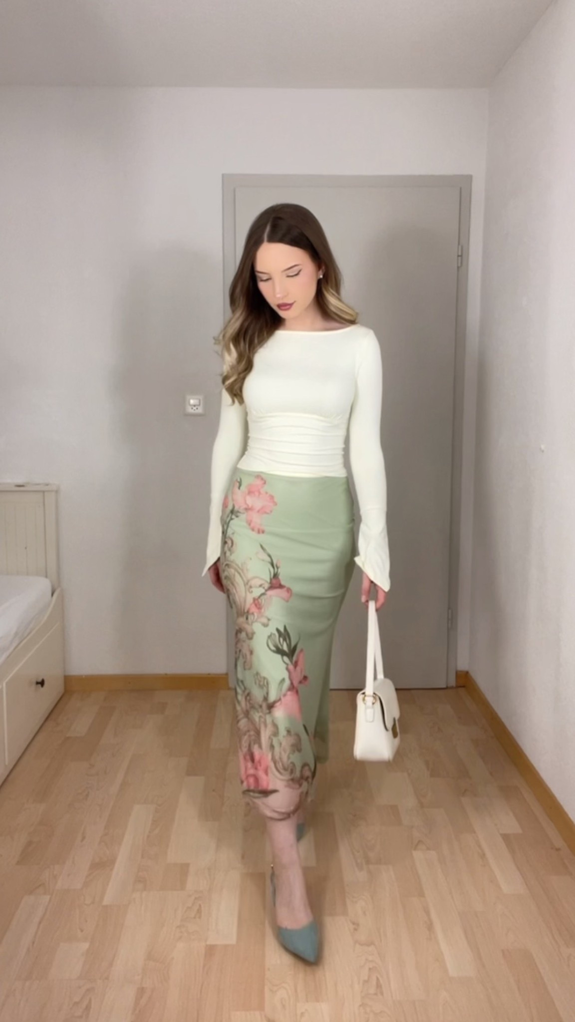 Florals for spring? Always a yes when they look this elegant. This stunning sage green satin midi skirt with a soft floral print brings the perfect balance of romantic and polished. I paired it with a fitted cream ruched top, mint heels, and a classic white shoulder bag to complete the look. It’s giving European garden stroll meets gallery opening. Soft, graceful, and effortlessly chic.

#LTKspring #romanticstyle #floralskirt #sagegreen #springfashion2025 #chicoutfitideas #gardenpartylook #feminineaesthetic #europeaninspired #floralaesthetic #quietluxuryvibes #springcolors #midiskirtstyle #softglamlook #minimalfeminine #mintgreenheels #classyoutfit #LTKstyleedit #LTKeurope #styleinspo #romanticspring