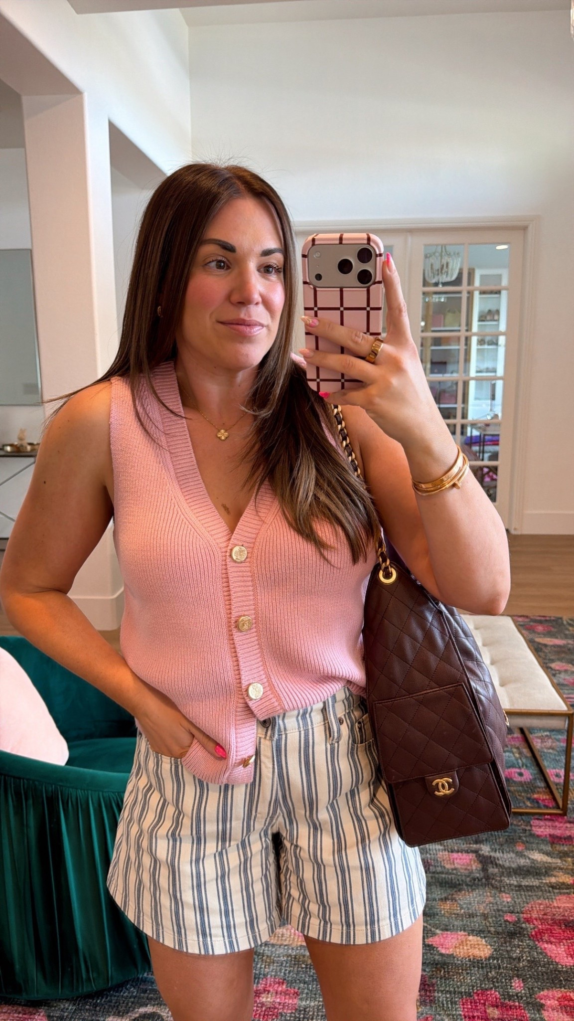 curvy midsize spring outfit! wearing size large on pink sweater vest and size 30 in blue and white striped shorts 

#LTKMidsize #LTKSeasonal