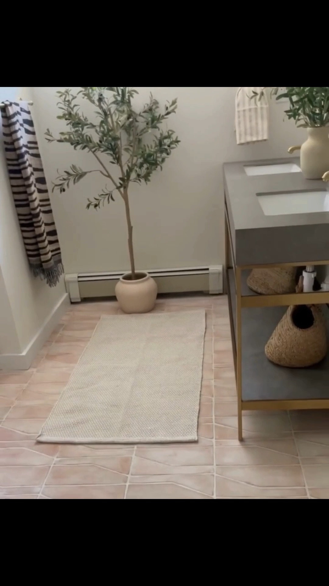 Hamptons basement bathroom with a cement gray double vanity, stone countertop, brass fixtures, wall-mounted mirror, and Zia Zocalo Blanco floor tile. We added a runner and simple storage below the vanity to bring in a little more warmth, texture, and function without overwhelming the space. Linking exact and similar pieces here.

#LTKActive #LTKSaleAlert #LTKHome