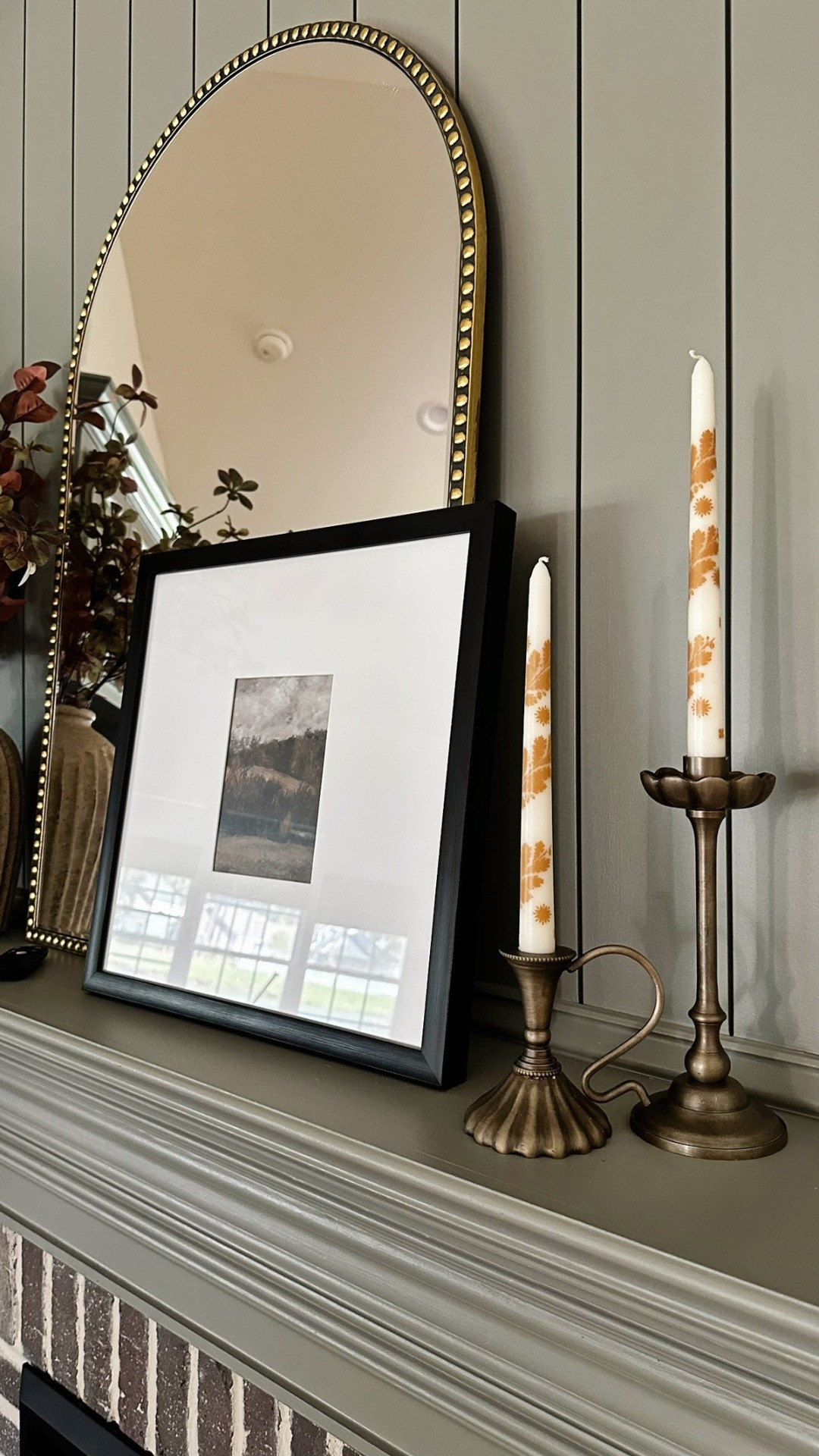 Fall fireplace decor! Brass candlestick holders, patterned taper candle set, matte black square picture frame, beaded antique gold accent mirror, fall stems

#LTKStyleTip #LTKSeasonal #LTKHome