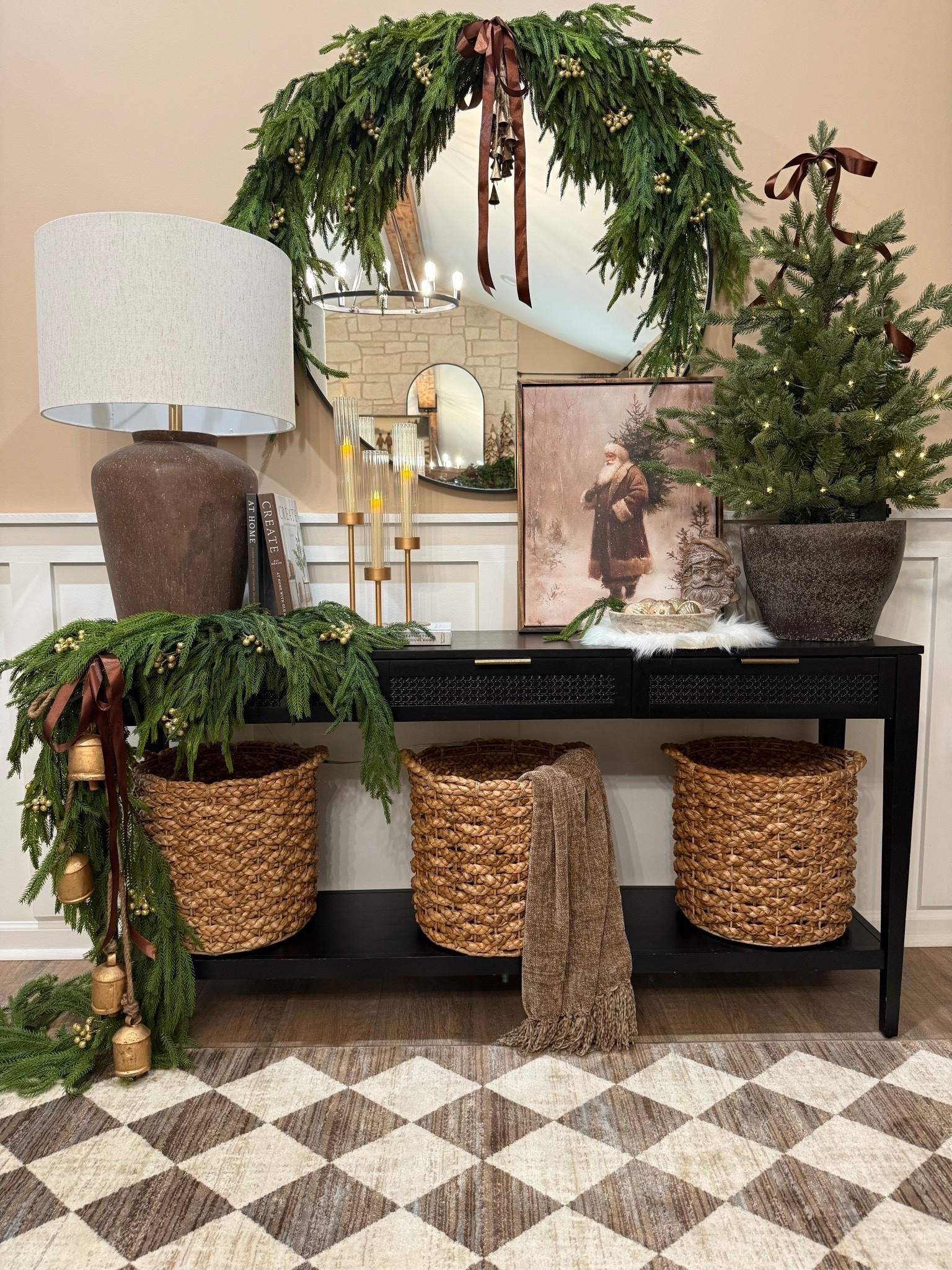 ✨A Nostalgic Christmas Console✨

Follow @farmtotablecreations on Instagram for more holiday styling inspiration.

This console gives me all the nostalgic Christmas feels. The artwork sets the tone with its classic charm, and I love how the layers of greenery, bells, and mixed textures make the whole space come alive. It’s full, cozy, and collected — just how I like it this time of year. Every detail adds to that feeling of old-fashioned Christmas warmth, the kind that instantly makes a room feel inviting.

For Reference:
Artwork 16x20 use code FARMTOTABLE for 15% off. 
Six Norfolk stems in swag. 
One garland and 2 Norfolk stems in console garland  

#christmasart #vintagesanta #christmasconsole #consoledecor #holidaystyling #christmasdecor #holidayhome #modernorganic #homedecor #christmasvignette #holidayartwork #checkeredrug