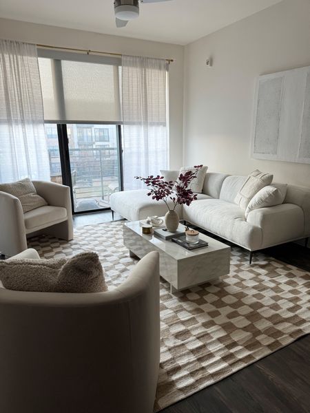 Neutral living room furniture & decor for small spaces or apartments. 🤍

Checkered rug, marble coffee table, cream sectional, cream barrel chairs, textured wall art, coffee table style. 

#LTKhome