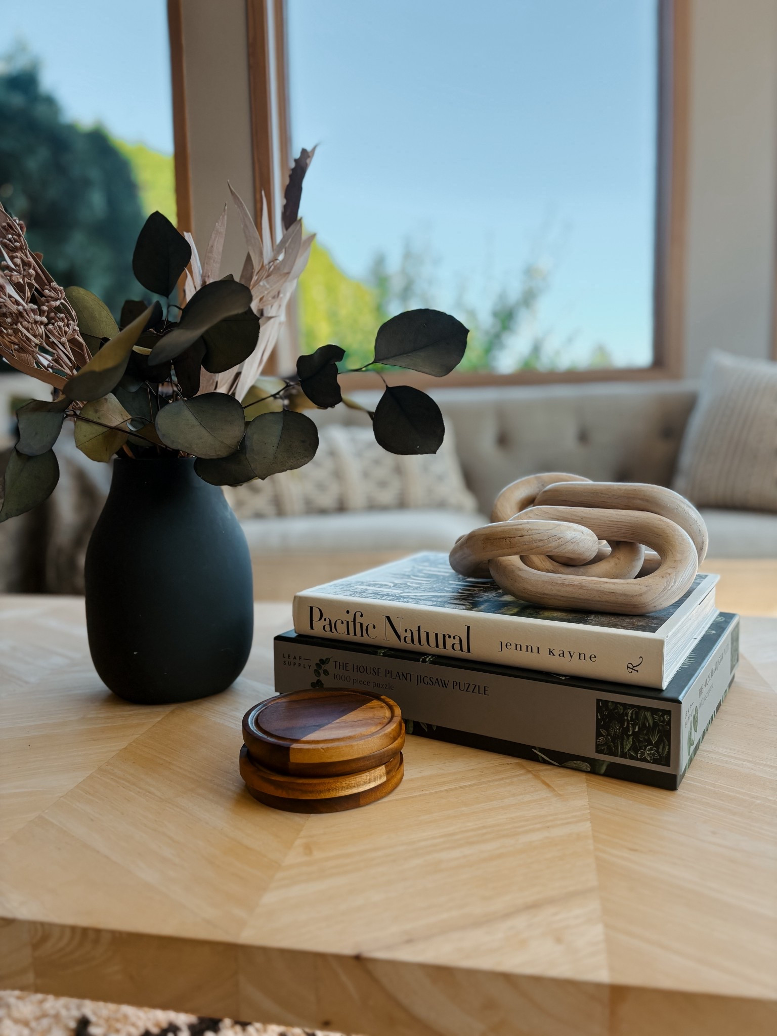 Super simple coffee table styling m; group in threes, start with height, then layer and stack and add some warmth.  🖤

Here I use my favorite black mat Face wood coasters, a coffee table book plus a puzzle and a wood chain 

#LTKHome