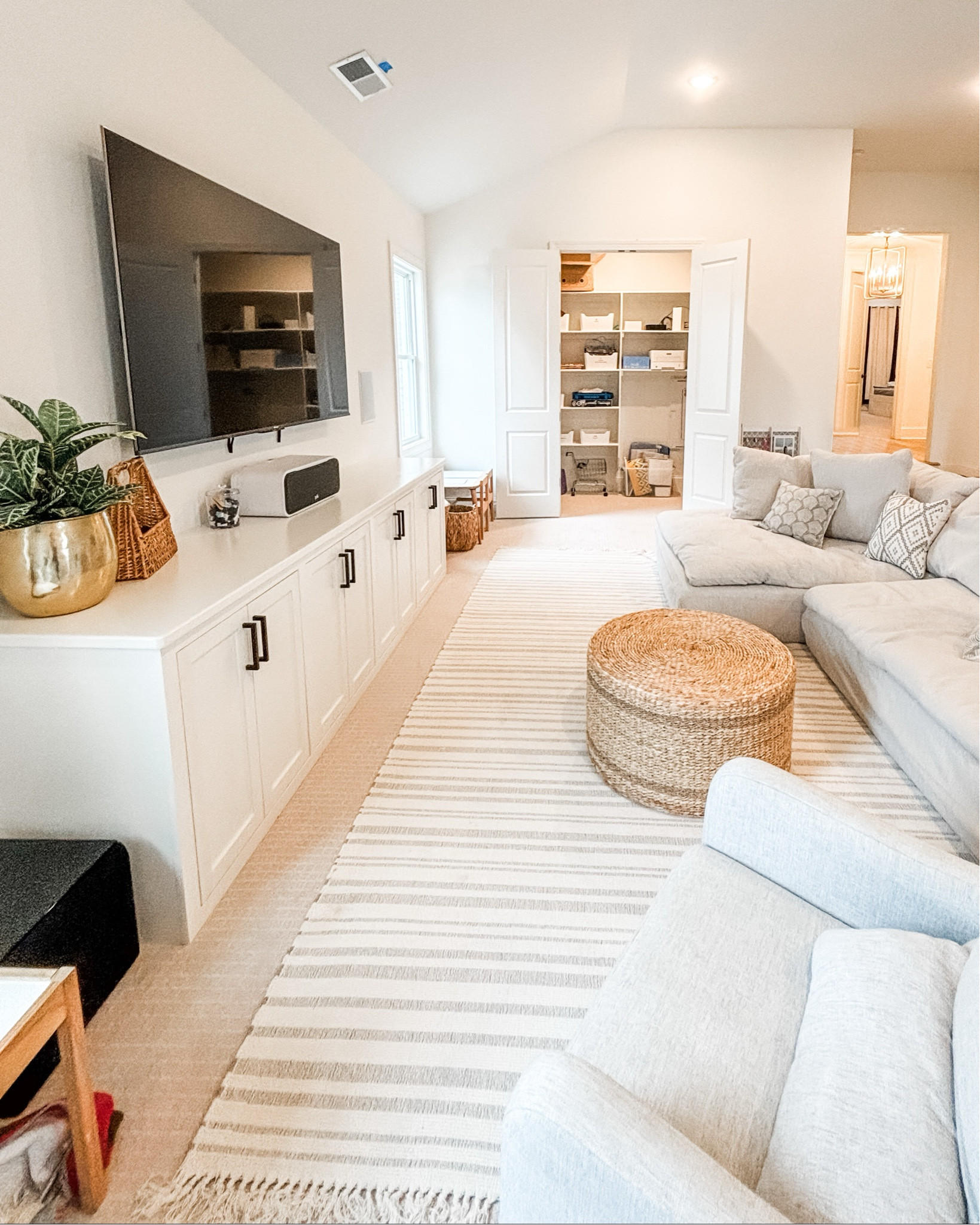 Would you believe us if we told you this is a playroom? Because it is! Playrooms do not always have to look like playrooms in a traditional sense - bursting with color, toys lining the walls, stuffed animals in every corner. Sometimes, a space can double as a playroom and also as a bonus room where parents, too, can hang out without feeling like they're surrounded by toys. Don't let us fool you though - the toys are right behind those cabinet doors and in the closet, which are just a tiny-hands-reach away for the little ones!
If you want help turning your space into a playroom that you, too, want to 'play' in, let us help!