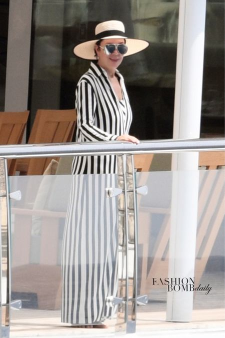 @krisjenner yachted it up wearing a $180 @normakamali striped cover up, $515 @porsche sunglasses, and a @maisonmichel hat. Shop her look at the link in our bio under “shop our feed.” Would you wear it?
📸 Backgrid #krisjenner #krisjennerfbd #normakamali 

#LTKSeasonal #LTKFind #LTKBacktoSchool