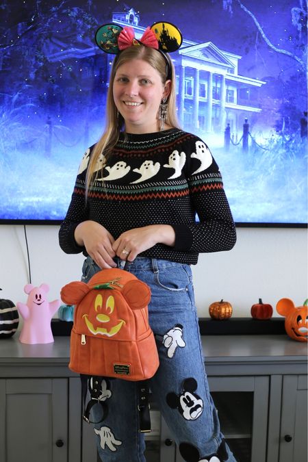 Halloween ghost sweater, Mickey Mouse jeans, pumpkin Mickey bag, and skeleton earrings  

#LTKHalloween