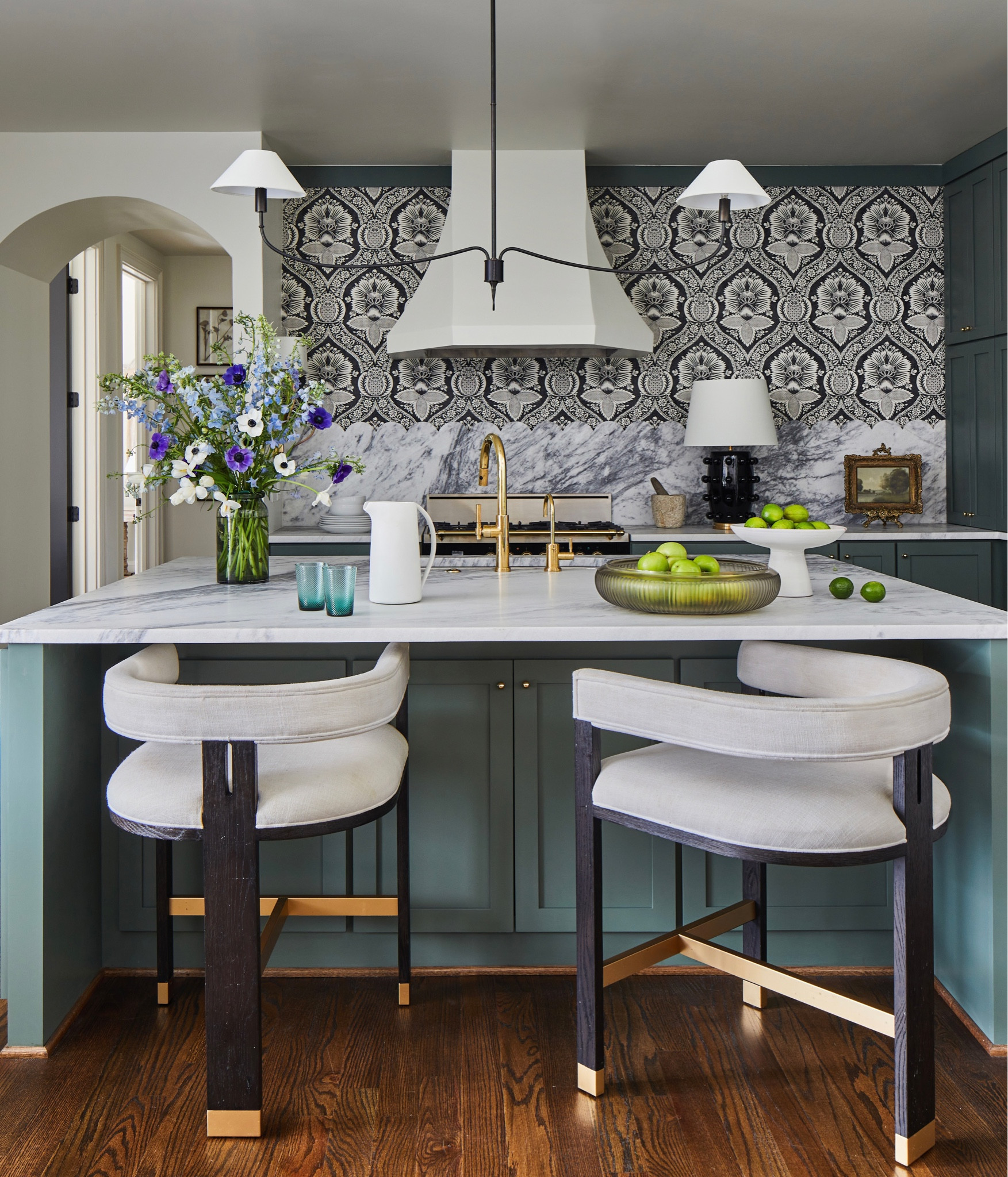 A stunning kitchen renovation project! Featuring modern & unique counter stools on sale, fun wallpaper, light fixture, & the perfect green paint color! 

#LTKhome #LTKsalealert