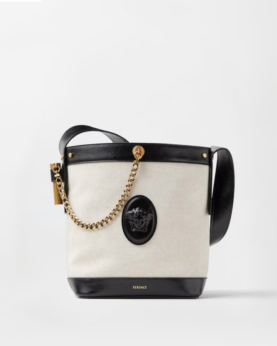 The Pivot canvas bucket bag is defined by leather trims and a central Medusa Cameo leather patch—a 3D rendition which captures the depth of Medusa's eyes and winged details in her hair. The accessory is enriched with a chain detail and a secure magnetic leather tab closure. For versatile styling, it can be carried in-hand or worn over the shoulder by the leather shoulder strap.
Medusa Cameo leather patch
Versace logo embossing
Chain detail
Top handles
Shoulder strap
One main compartment
1 interior flat pocket
Interior protector strap
Outer composition: 59% Linen, 41% Cotton
Trim: 100% Calf leather
Size & Fit
L9.1 x W6.7 x H10.6" / L23 x W17 x H27 cm
Handle drop: L2.4" / L6 cm
Shoulder strap: L36.2" / L92 cm
Shoulder strap drop: L12.6" / L32 cm

#LTKSaleAlert #LTKdayinmylife #LTKU