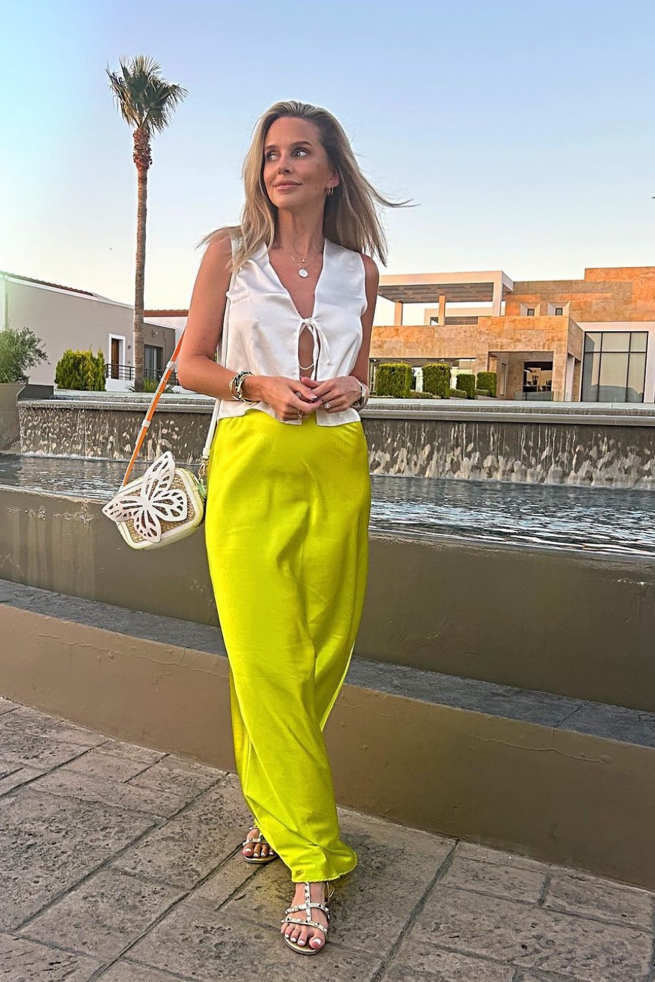 Satin tie front top, white top, yellow satin maxi skirt, pink silk skirt, butterfly bag, heeled sandals, Sophia Webster, holiday outfits  

#LTKSeasonal #LTKstyletip #LTKeurope
