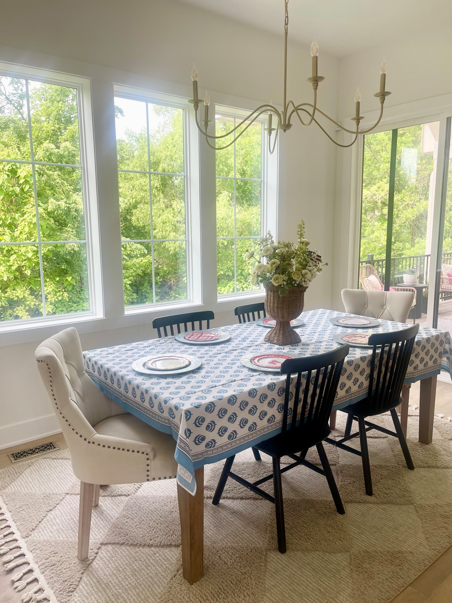 4th of July dining table setting! Black dining table chairs, white fabric dining table chair, blue table cloth. Gold light fixtures. 

#LTKSeasonal #LTKHome #LTKSummerEdit