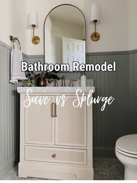 Bathroom remodel, reeded vanity, marble tile, arch mirror, brass sconces, skirted toilet, towel hook, toilet paper holder 