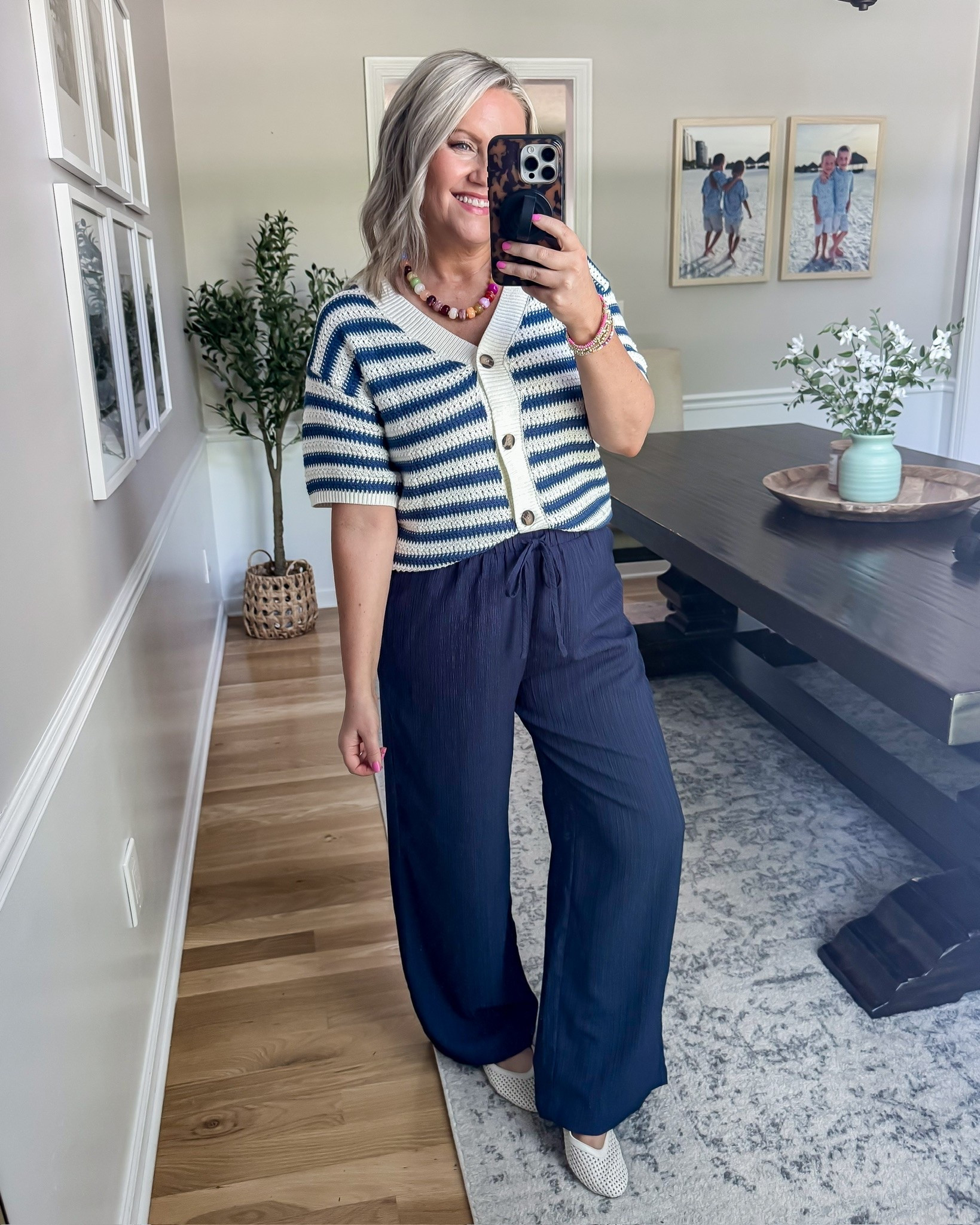 This outfit feels so chic and effortless for spring and summer. The striped knit cardigan gives that elevated coastal feel, and these navy flowy pants are unbelievably comfortable while still looking polished. Such a good outfit for work, brunch, vacation dinners, or anytime you want to look put together without sacrificing comfort.

striped cardigan outfit, navy wide leg pants, coastal chic outfit, effortless spring style, classy casual outfit, comfy dressy outfit, european summer style, lightweight knit top, teacher outfit idea, vacation outfit inspiration, casual elegant style, neutral chic fashion, lovelylifestyling

#LTKootd #LTKSeasonal #LTKOver40