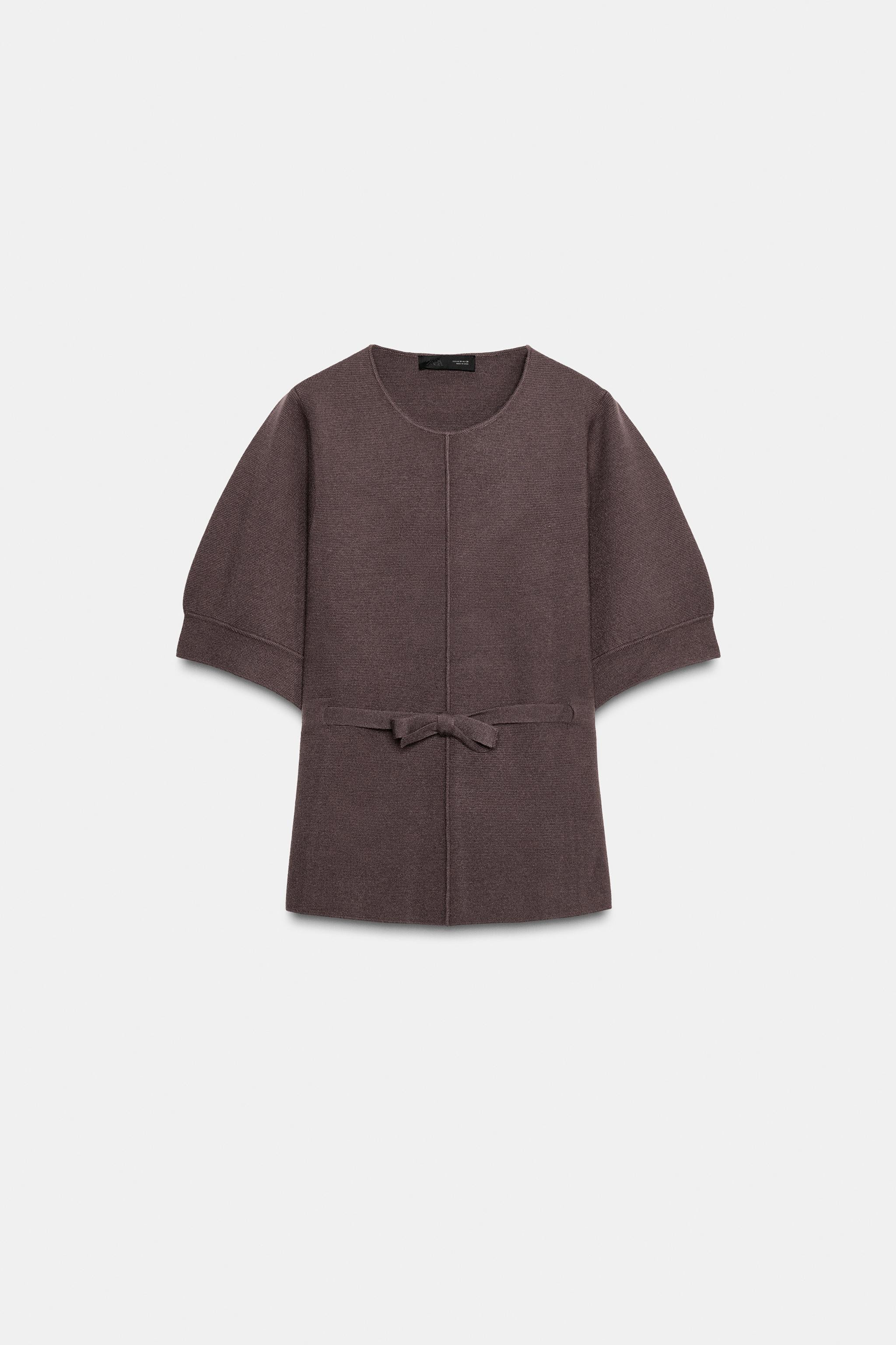 Round neck sweater with short puff sleeves. Features marked rib detail and front tie. | Zara US