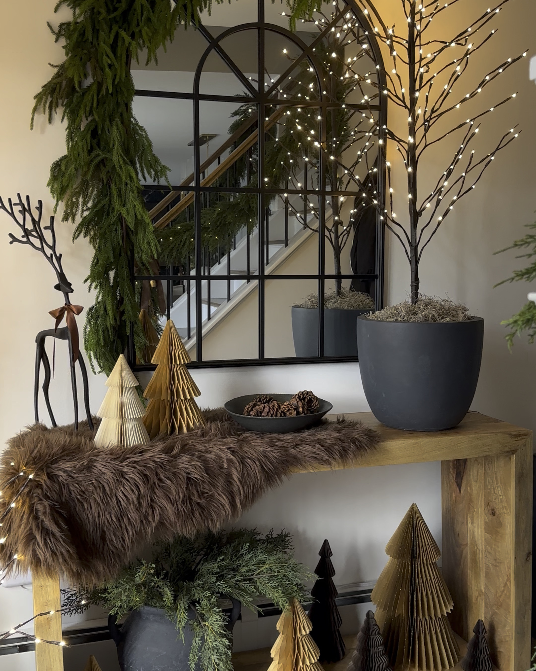 Twinkle trees in planters. Holiday decor. Christmas foyer. Elevate your twinkle trees. Kante planter, Norfolk pine, arch mirror, faux fur hide, reindeer, Ruggable runner, accordion trees.

#LTKHome #LTKHoliday