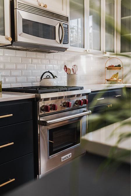 Two toned kitchen look with white and navy blue cabinetry.

Brass hardware. White beveled subway tile. White crock. 

#LTKStyleTip #LTKFindsUnder50 #LTKHome