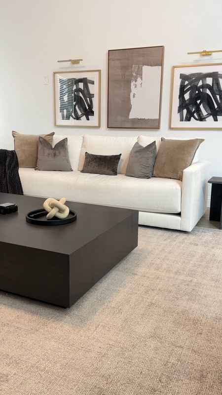 Shop our living room decor 🥰 Modern Cream sofa, grey faux linen curtains, large coffee table, cream boucle accent chairs, grey and hod accent chair, black marble side table and contemporary wall art.

#LTKstyletip #LTKU #LTKhome