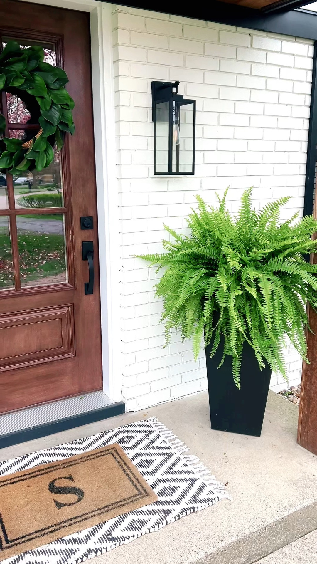 Front porch planters! ☀️ Spring has sprung and I was so excited to get my ferns this week! I always find that Costco has the best ones so I snagged 6 of them while I was there! Need a new door mat and rug and can’t wait to add some flower pots in front of the ferns 🪴 🌸 #frontporch #springporch 

#LTKxTarget #LTKfamily #LTKSeasonal