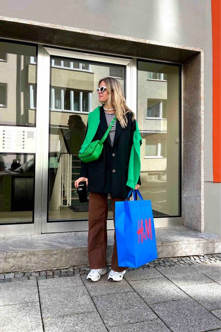 Brown Denim. Fashion Blogger Girl by Style Blog Heartfelt Hunt. Girl with blond hair wearing brown denim pants, striped tee, white cat-eye sunglasses, oversized blazer, green sweatshirt, green braided bag and New Balance sneakers. #colorfuloutfit #colorfulstyle #colorfulfashion #colorfullooks #fashionfun #cutefalloutfit #fallfashion2023 #falllookbook #fitcheck #dailylooks #dailylookbook #contentcreator #microinfluencer #discoverunder20k