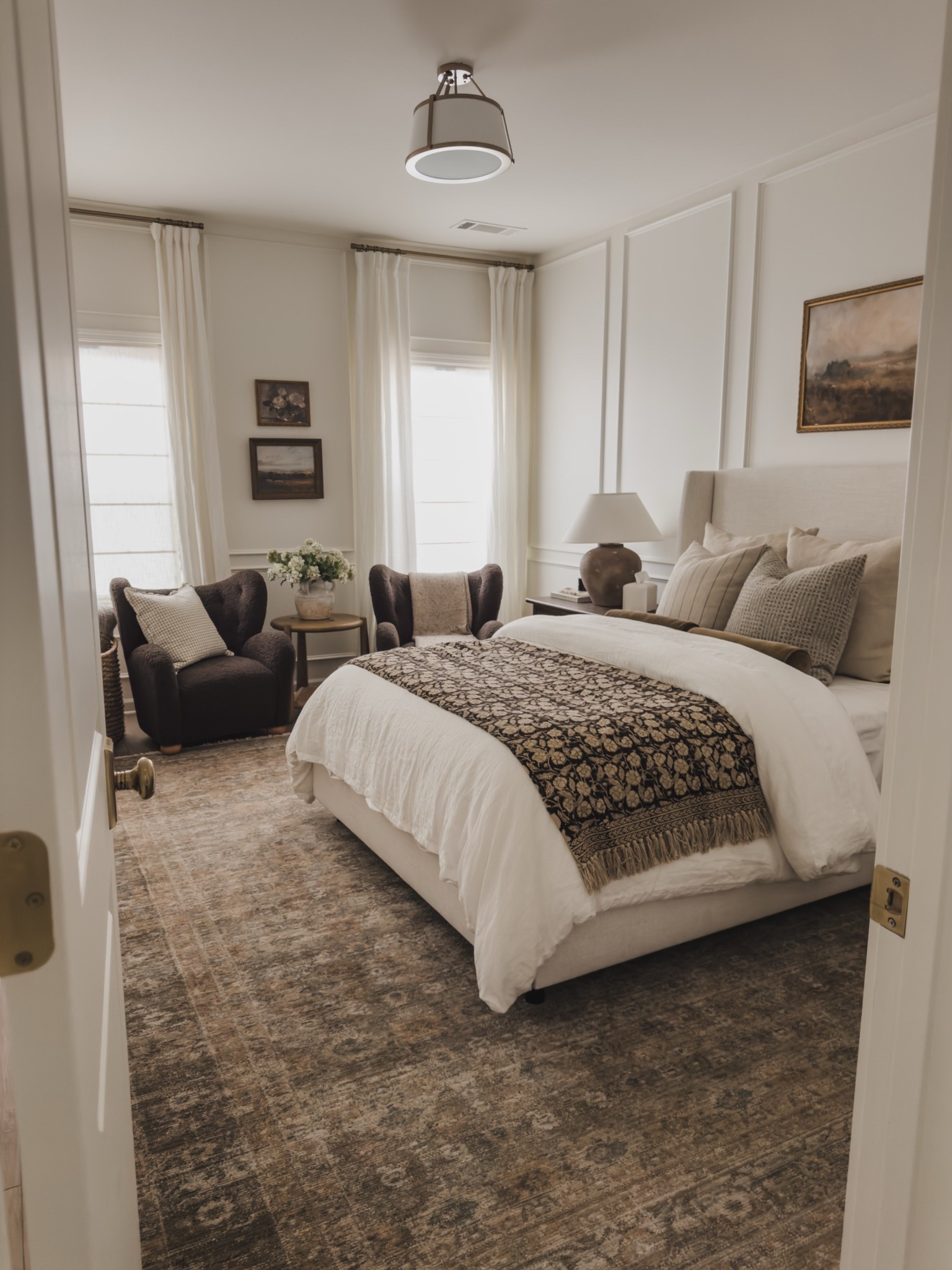 Timeless and cozy guest bedroom vibes! While this view isn’t shared as often, it’s one of my most loved spaces that gives all the warmth and layered feel.

Home finds, neutral home inspo, collected style, furniture favorites, neutral wood tones, cozy accent seating, upholstered bed frame, linen detail, vintage inspired area rug, cozy bedding, fall refresh, guest bedroom refresh, wainscoting detail, moody accent chair, brass detail, Wayfair, Loloi, Amber Lewis, Birch Lane, Two Pages, Pottery Barn style, Etsy, shop the look!

#LTKSeasonal #LTKHome