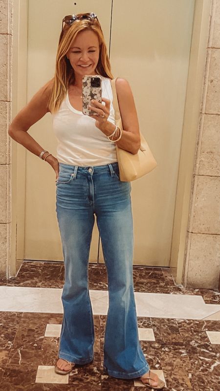 Enzo Costa racerback white tank top and Paige Genevieve High Rise Flare Jeans, Fit TTS. Tank is pima cotton—super soft.   Casual OOTD. 

#LTKtravel #LTKunder100 #LTKstyletip