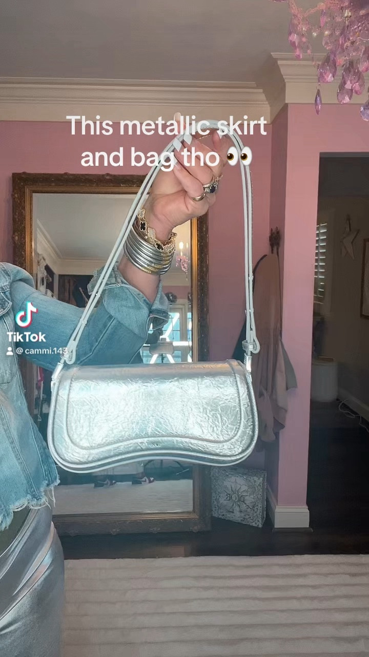 I am loving this whole metallic look. I think the bag just brings it all together. Accessories can really make an outfit. I love the skirt I am wearing a size large, but it does have some stretch to it. It really hugs the curves nicely. I am pairing it with a graphic t I can’t find the exact, but I will look for some alternatives. For more midsize, curvy fashion follow cammyrobinson here 🫶

#LTKstyletip #LTKitbag #LTKmidsize