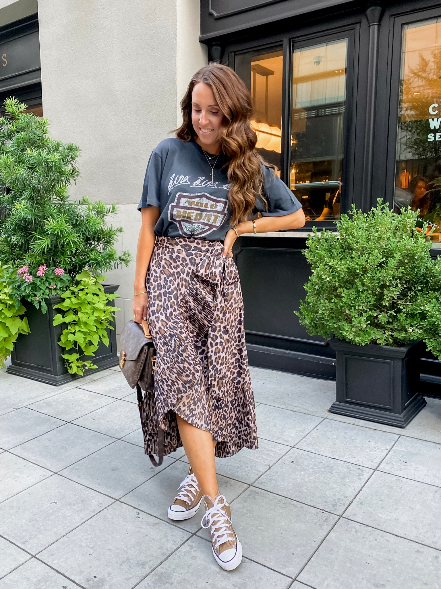 Anthropologie asymmetrical skirt. Wrap skirt. Leopard skirt. Dressy casual style. Maxi skirt. Converse all-star sneakers. Anine Bing graphic tee. 
Tee S. Skirt XS petite. Sneakers down 1/2 size. 

#LTKstyletip #LTKshoecrush #LTKSeasonal