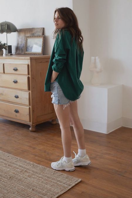Caroline Joy of Unfancy wears a casual summer outfit featuring a bold green button down shirt with denim cutoff shorts and sneakers.

#LTKshoecrush #LTKSeasonal #LTKunder100