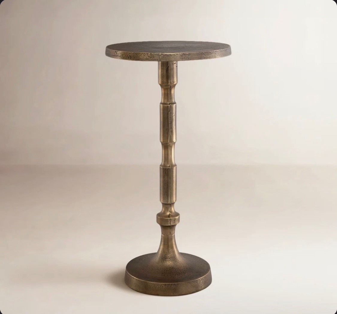 Picture a chic accent piece that feels both light and substantial. This pedestal end table does just that. Crafted from heavily textured cast aluminum and coated in antique brass, it delivers a vintage-inspired glow. The scalloped edges soften its round top (12″ wide) and the 24″ height pairs beautifully with sofas or accent seating. Despite its airy profile, the sturdy cast form supports your essentials with ease. Weighing just over 7 pounds and arriving fully assembled, this table offers instant polish and functional charm, ideal for elevating cozy nooks with minimal fuss

#LTKHome