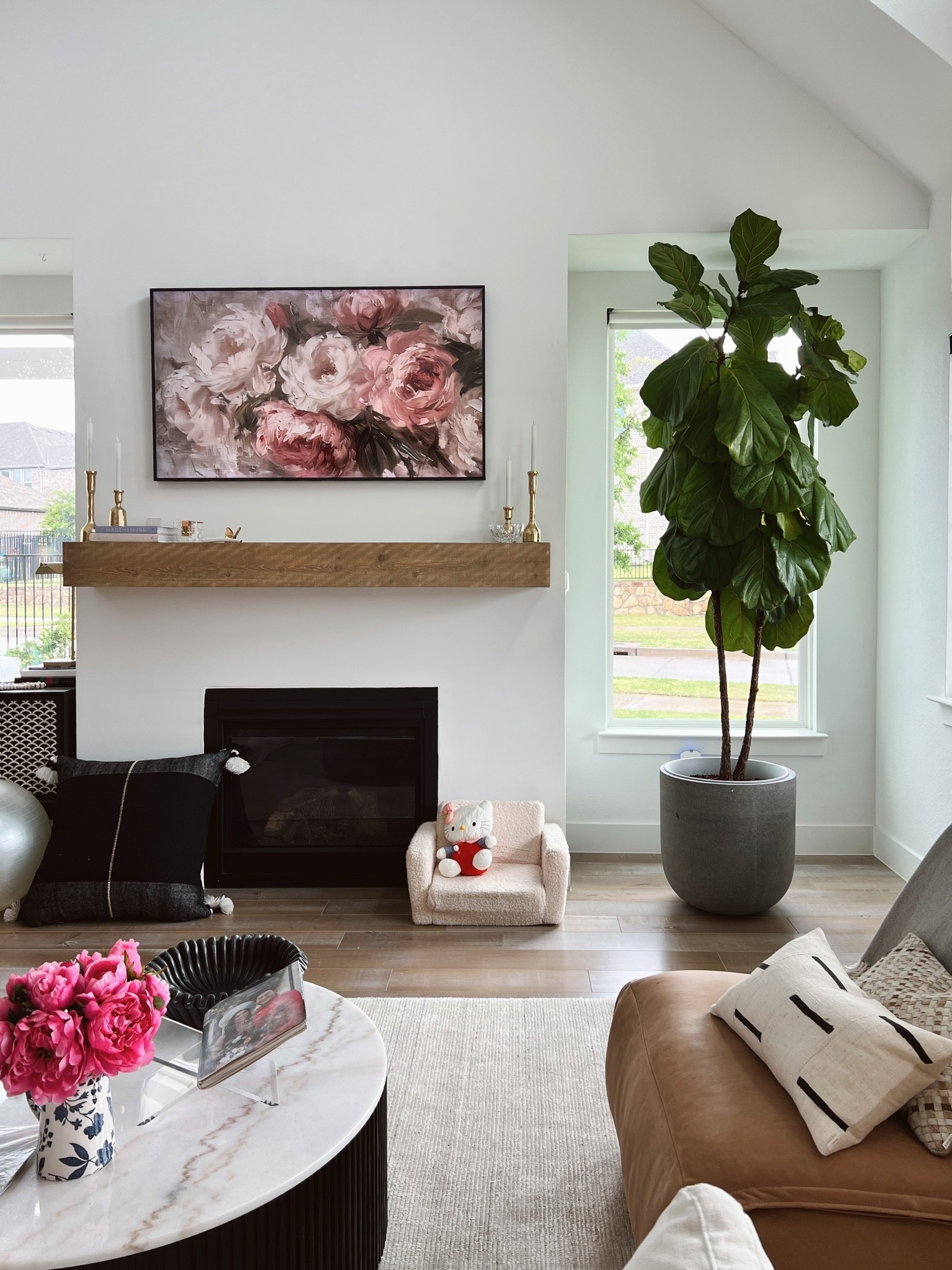 Calm and tranquil living room, even with a toddler! We’ve had this decorative planter pot for years and it is in great condition. We have our fiddle leaf fig in a plastic pot the decorative planter. Also linking our favorite leather recliner, throw pillows and white sofa.