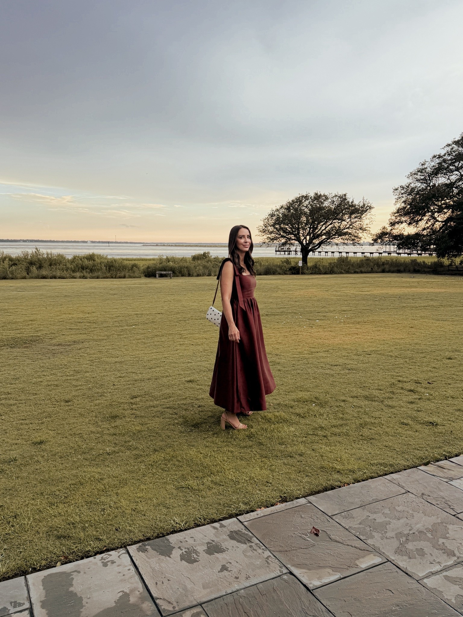 A rich burgundy midi dress with tie-strap detailing is the perfect fall wedding guest look — timeless, flattering, and ideal for waterside or garden ceremonies. This deep wine tone is a standout choice for autumn weddings, paired here with a polka dot bag for a playful finishing touch.

#LTKWedding #LTKOver40