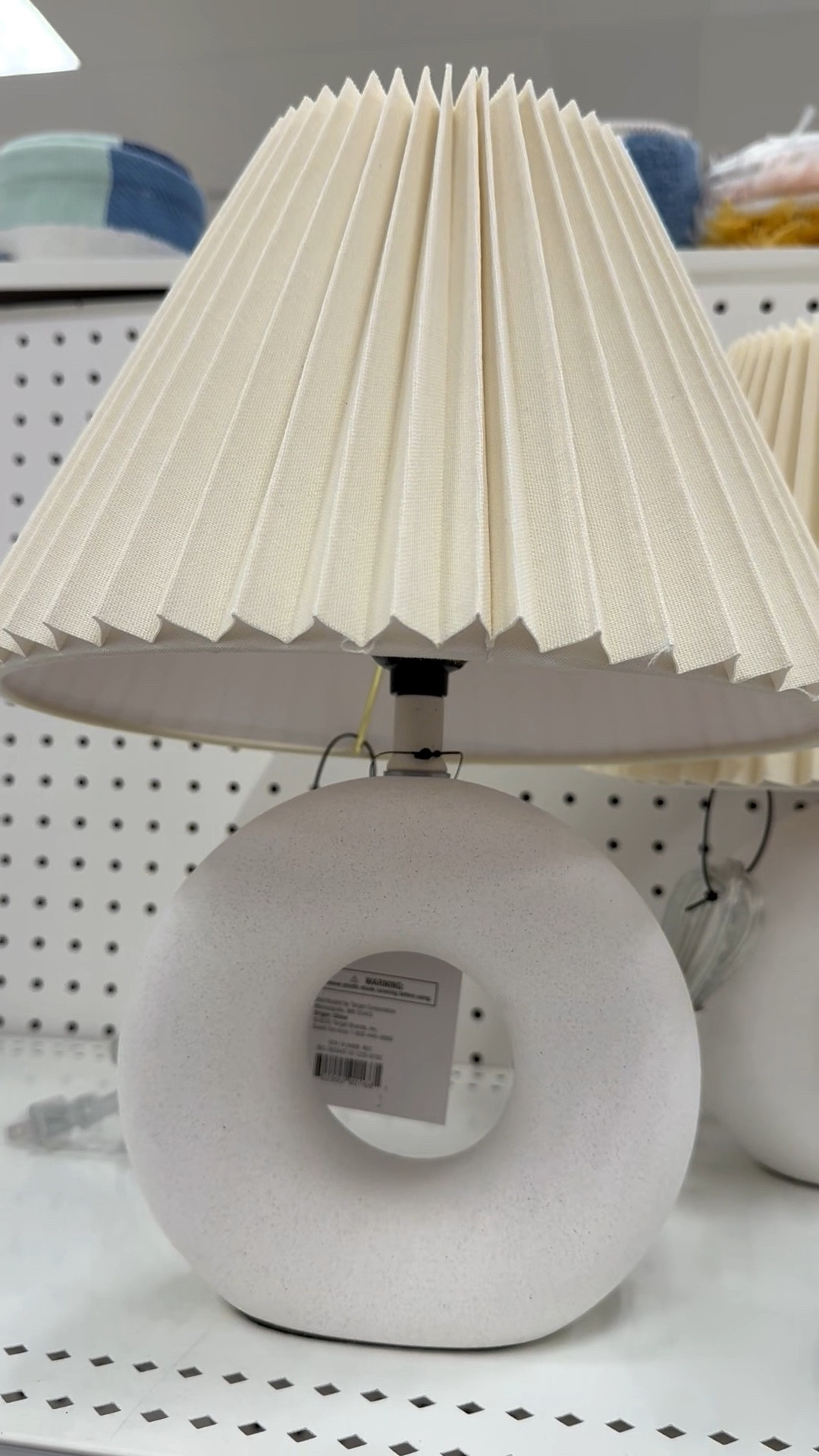 This modern-style table lamp features a round cutout design, empire-shape pleated lamp shade, and a socket turn knob. It’s perfect for an entryway, nightstand, and end table. Available in black as well.💡

And if you’re a mosaic artist, this would be a fun substrate for your tile work too! For mosaic tips, tutorials + inspiration please visit my YouTube channel: YouTube.com/julieweilbacher, and follow @julieweilbacher on Instagram.

#ceramiclamp #modernlamp #pleatedlampshade #entrywaylamp #springhomedecor #target #tablelamp #mosaic #whitetablelamp

#LTKHome