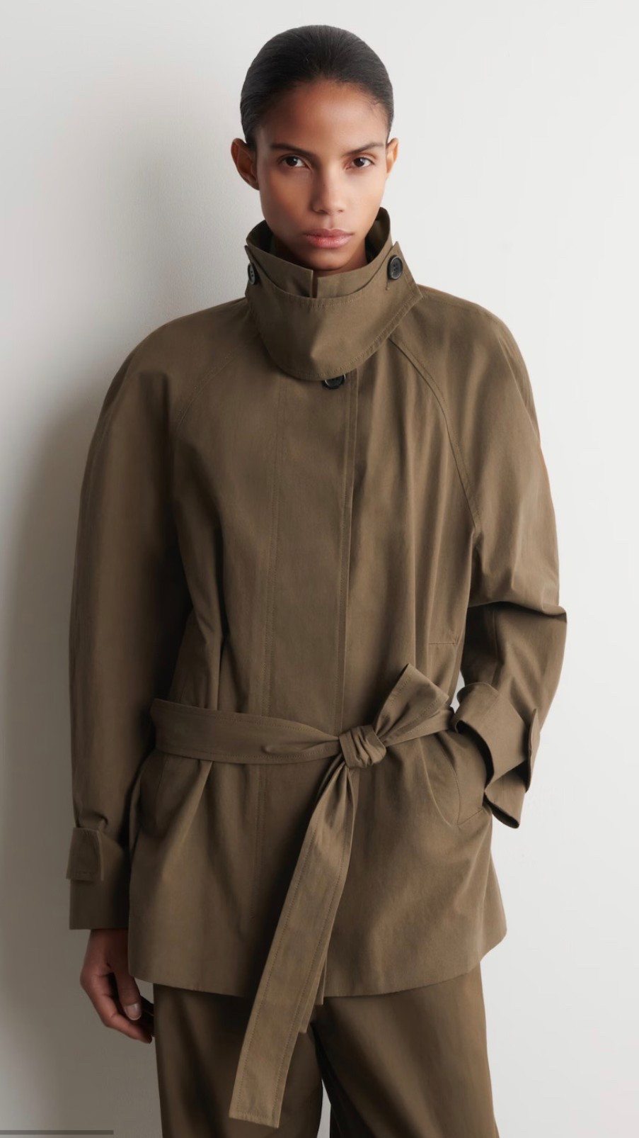 BELTED COTTON SHORT TRENCH COAT

for transitional styling. Crafted from lightweight cotton, this piece is designed with a throat latch so that you can experiment with the shape – opt for a mock neck or classic collar. It's finished with timeless details such as the storm flap and tonal belt

#LTKWorkwear #LTKSeasonal #LTKTravel