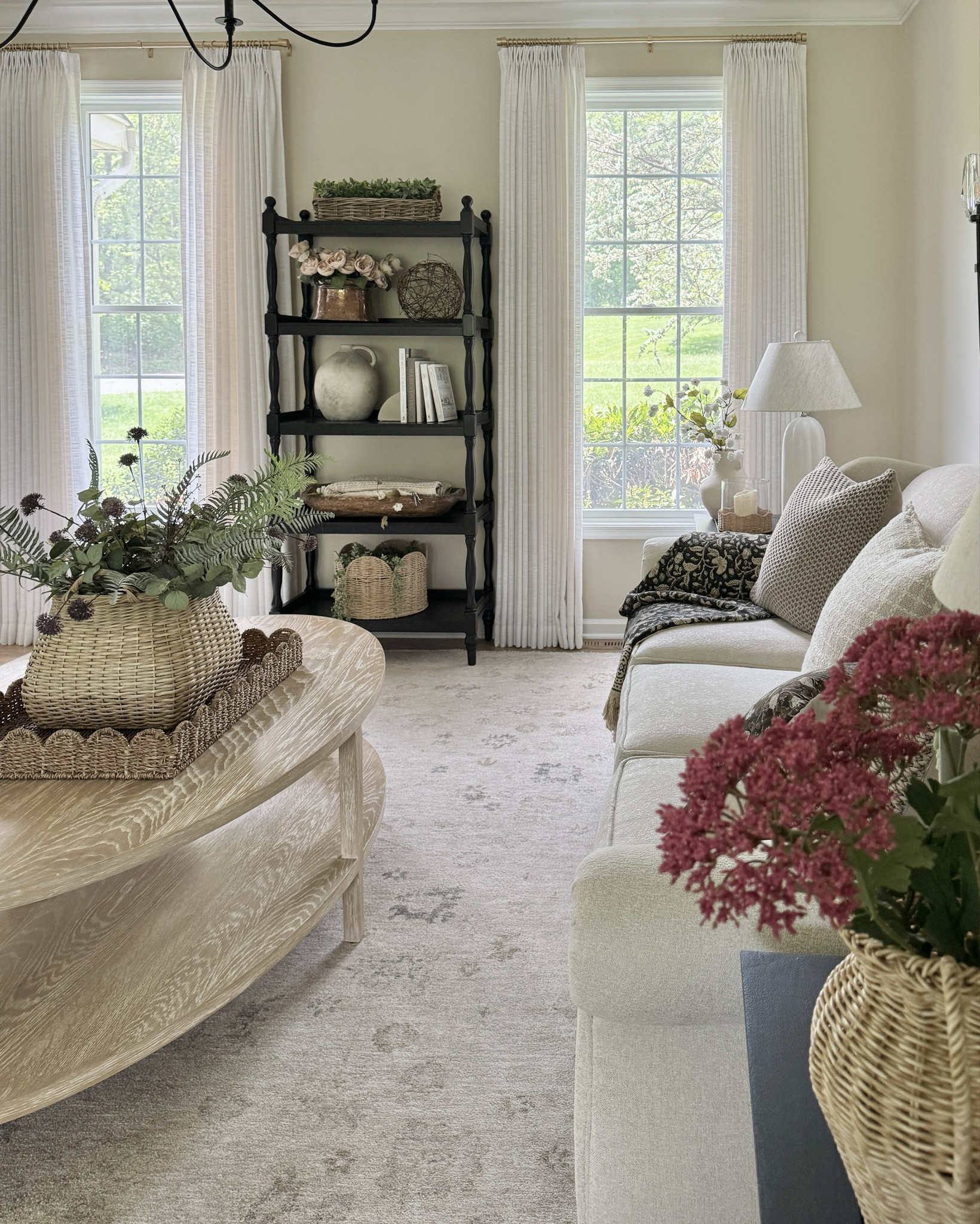 Sale alert: my area rug is currently on sale. It’s the prettiest soft neutral rug that has enough of a design to make it unique but not so much that it’s too busy. Also sharing my onyx bookshelf at a very fair price! Also our black curved arm chandelier, oval solid wood coffee table, electric wall sconces, woven tray and basket, framed wall art, beige linen curtain and hardware and pretty black floral throw  

#LTKSaleAlert #LTKHome