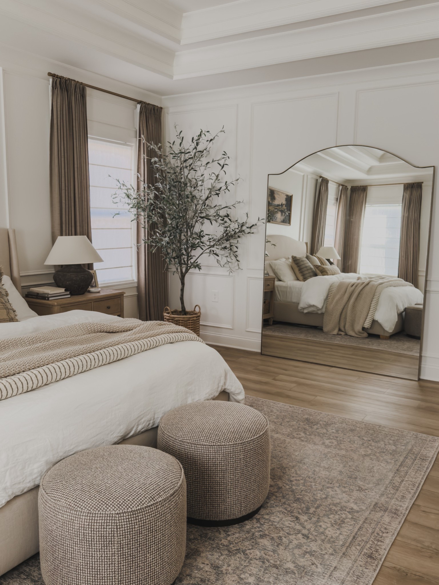 One of my favorite bedroom views showcasing my stunning, oversized floor mirror. I knew I wanted something impactful to the space to make it feel grand - and this mirror did just that! I received so many compliments on its appearance and truly ties into the timeless style. 

Home finds, neutral home inspo, primary bedroom refresh, collected style, cozy bedding, timeless home inspo, neutral area rug, vintage style area rug, ottoman details, upholstered bed, linen bed frame, linen bedding, oversized floor mirror, faux olive tree, woven basket, pinch pleat curtain, linen curtain, roman shades, coy throw blanket, throw pillow details, nightstand favorites, neutral wood tones, wainscoting detail, Wayfair, Four Hands, Pottery Barn style, Galey Alix, Livabliss, Two Page, Target style, Quince, Etsy, Loloi, Amber Lewis, shop the look!

#LTKHome #LTKSeasonal