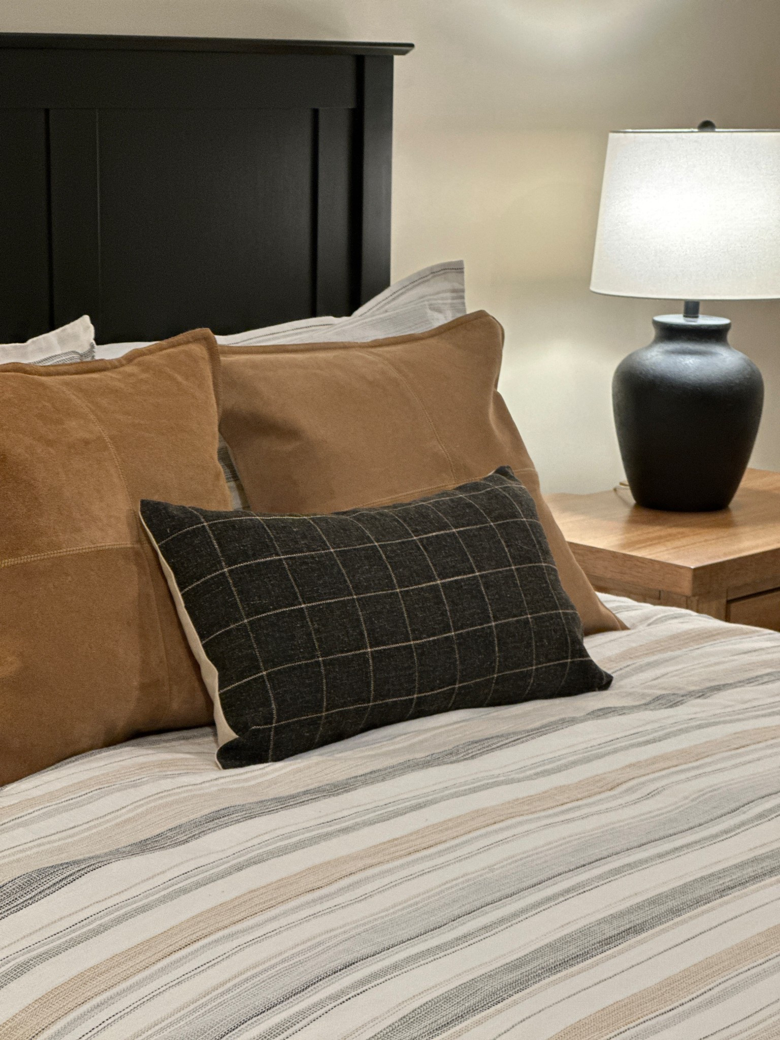 A mountain style bedroom refresh with neutral colors and an apres ski vibe!  Plaid pillow and suede pillows on striped bedding with d black bed and black lamp.

#ltkmountainaesthetic

#LTKHome #LTKSeasonal