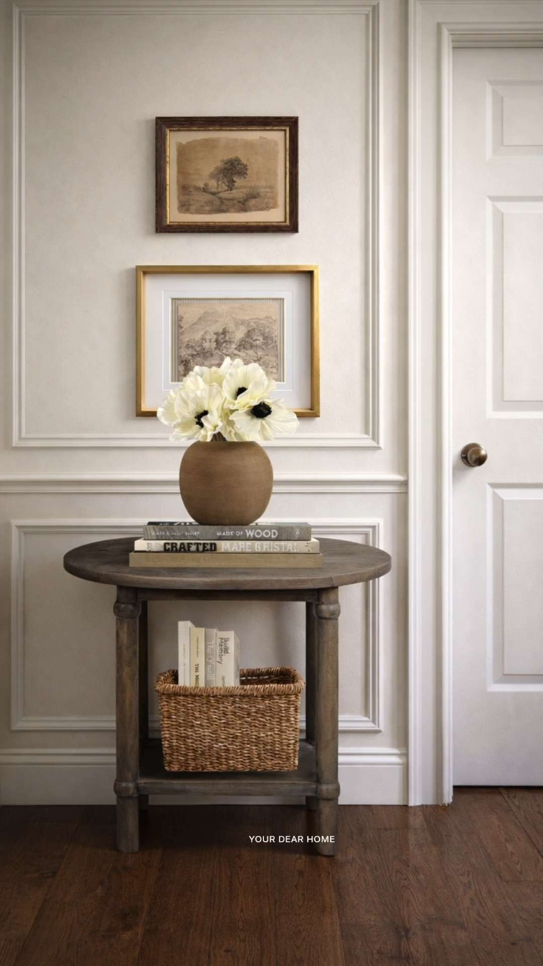 Small hallway? This is how you make it feel styled without overcrowding it. A compact round table with a lower basket adds function, while the layered art and soft florals bring in just enough detail to make it feel complete. 

 #LTKHome