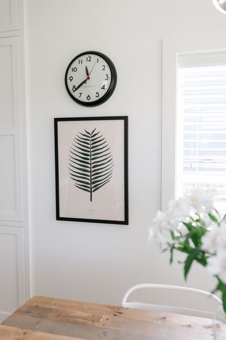 On this empty wall between our kitchen and dining room I stacked an art print and Schoolhouse clock  

#LTKhome #LTKFind #LTKstyletip